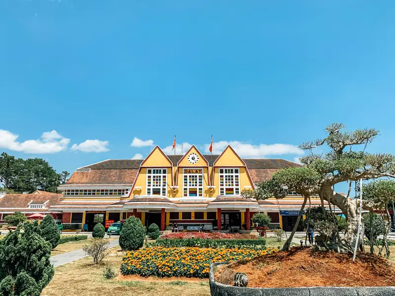 The yellow Da Lat railway station under a blue sky